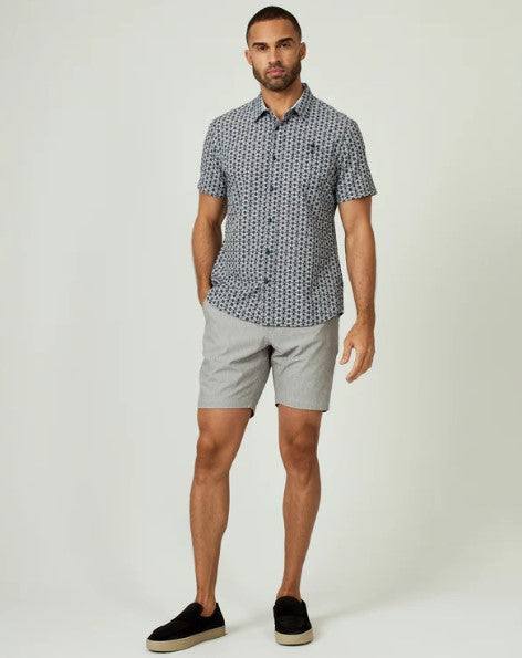 Man wearing 7 Diamonds Everest 8" Short with patterned shirt and black slip-on shoes