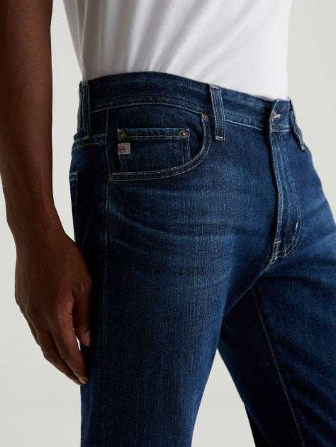 Men wearing AG Tellis Modern Slim 360° Stretch Denim jeans in medium wash with tapered fit and modern slim silhouette