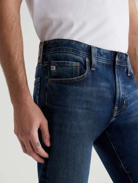 AG Tellis Modern Slim men's jeans in medium indigo wash with tapered leg and stretch Flex 360° Denim