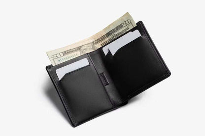 Bellroy Note Sleeve black leather wallet holding cards and a flat bill with RFID protection