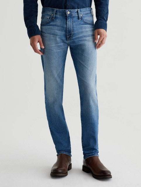 AG Tellis slim-fit modern dark indigo denim jeans with tapered legs and subtle fading