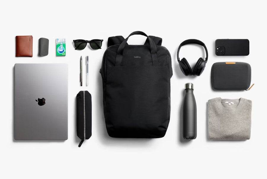 Bellroy Via Workpack black commuter backpack with laptop and accessories arranged around it