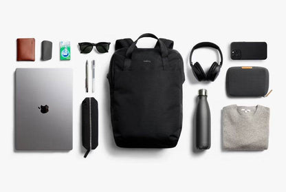 Bellroy Via Workpack black commuter backpack with laptop and accessories arranged around it